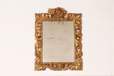 Lot 392 - A carved giltwood and gesso wall mirror