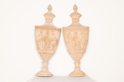 Lot 378 - A pair of flat-back cast composite stone urns after a Coade model