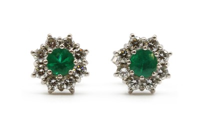 Lot 229 - A pair of white gold emerald and diamond cluster earrings, by Fred Ullmann