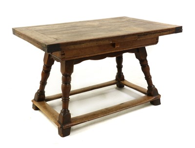Lot 465 - A Continental provincial fruitwood draw leaf table