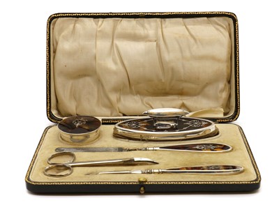 Lot 29 - A George V silver manicure set