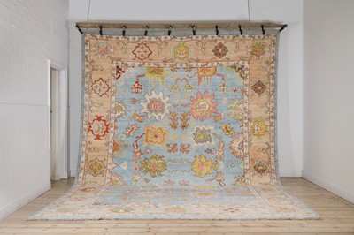 Lot 214 - A large Oushak wool carpet