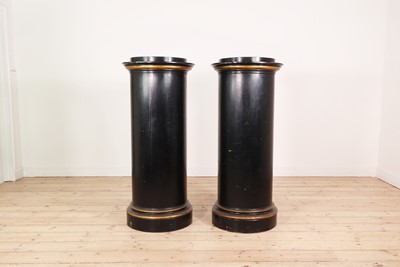 Lot 405 - A pair of ebonised pedestal columns