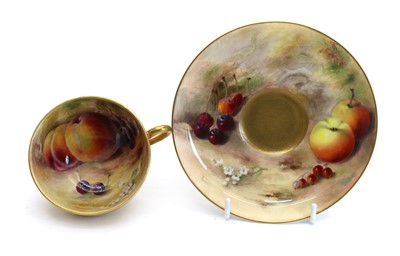 Lot 52 - A Royal Worcester porcelain Fallen Fruits teacup and saucer