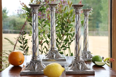 Lot 354 - A set of four silver candlesticks
