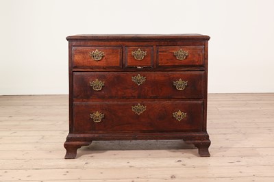Lot 619 - A George II elm chest of drawers
