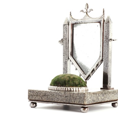 Lot 162 - A steel-framed miniature dressing table mirror and pincushion