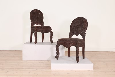 Lot 46 - A pair of carved teak chairs