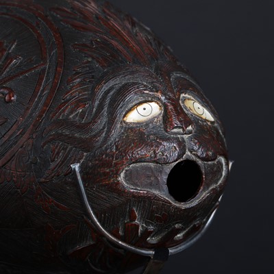 Lot 101 - A carved 'bugbear' coconut flask