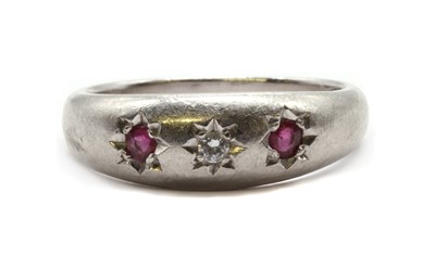 Lot 88 - A platinum three stone diamond and ruby ring