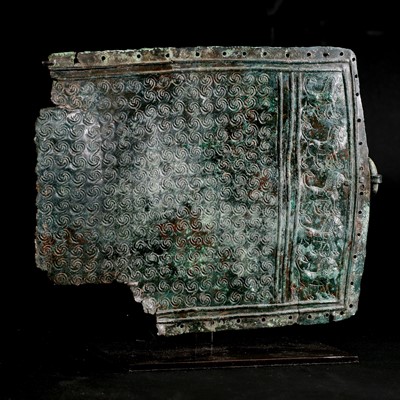 Lot 224 - A bronze belt plate section