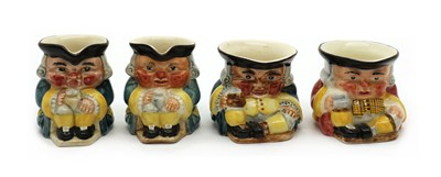 Lot 137 - A collection of four Clarice Cliff miniature toby jugs