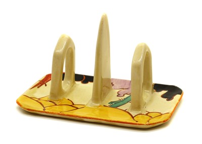 Lot 146 - A Clarice Cliff 'Summerhouse' three-bar toast rack