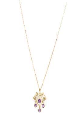 Lot 1292 - An Edwardian-style gold amethyst and split pearl pendant