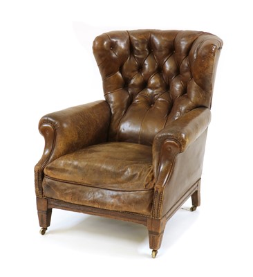 Lot 521 - A brown leather library armchair