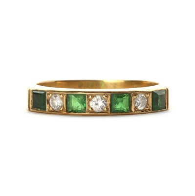 Lot 1237 - An 18ct gold tsavorite garnet and diamond half eternity ring