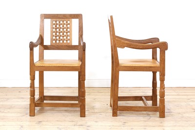 Lot 105 - A pair of Robert 'Mouseman' Thompson oak dining chairs