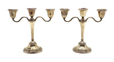 Lot 14 - A pair of silver three branch candlesticks