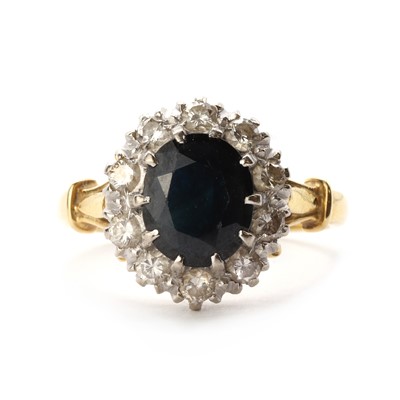 Lot 1280 - A gold sapphire and diamond cluster ring