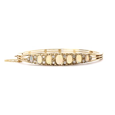 Lot 1320 - A gold opal and diamond oval hinged bangle