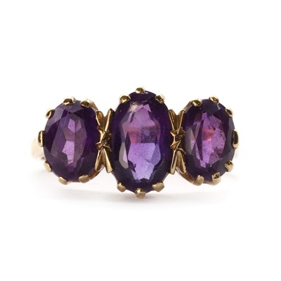 Lot 1299 - A 9ct gold three stone amethyst ring, by Shipton & Co.