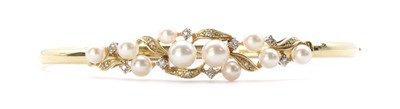 Lot 1347 - A 9ct gold cultured pearl and diamond set oval hinged bangle