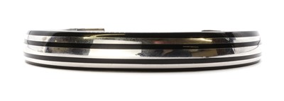Lot 1247 - A sterling silver and black resin torque bangle, by Montblanc