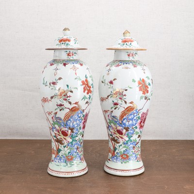 Lot 429 - A pair of Chinese famille rose vases and covers