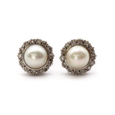 Lot 1345 - A pair of white gold cultured pearl and diamond cluster earrings