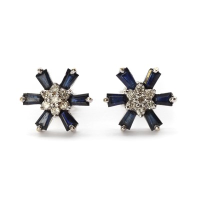 Lot 1268 - A pair of white gold diamond and sapphire cluster earrings