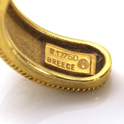 Lot 312 - A gold and ruby Etruscan style torque ring, by Ilias Lalaounis