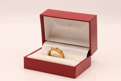 Lot 312 - A gold and ruby Etruscan style torque ring, by Ilias Lalaounis