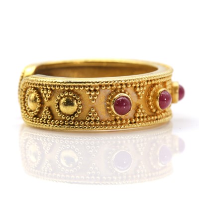 Lot 312 - A gold and ruby Etruscan style torque ring, by Ilias Lalaounis