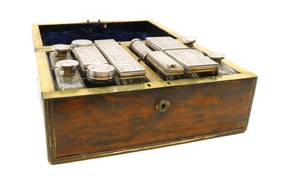 Lot 59 - A cased silver topped dressing table set