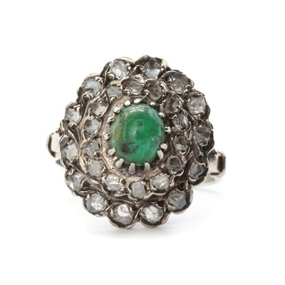 Lot 1234 - A gold cabochon emerald and diamond cluster ring