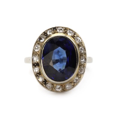 Lot 1267 - A white gold synthetic sapphire and diamond cluster ring