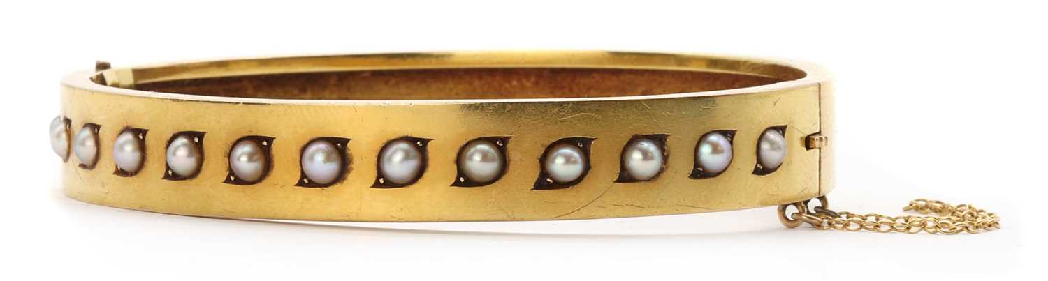 Lot 1027 - A Victorian gold split pearl bangle