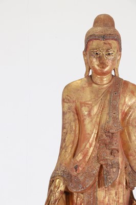 Lot 242 - A lacquered and giltwood standing Buddha