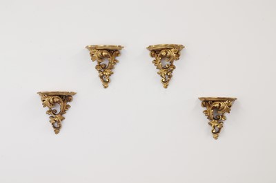 Lot 64 - A set of four giltwood wall brackets