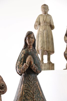 Lot 14 - A group of carved and polychrome-painted wooden saints