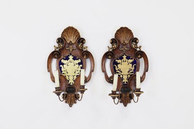 Lot 21 - A pair of walnut, parcel-gilt and verre églomisé wall sconces