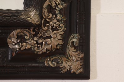 Lot 106 - An ebonised fruitwood mirror