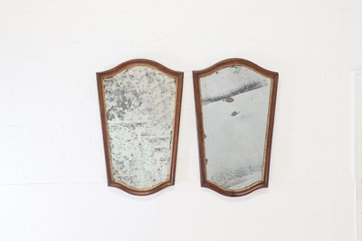 Lot 296 - A pair of walnut and parcel-gilt mirrors