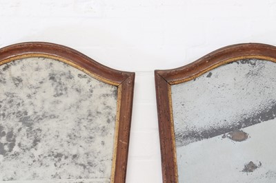 Lot 296 - A pair of walnut and parcel-gilt mirrors