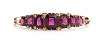Lot 61 - A late Victorian almandine garnet and diamond hinged bangle