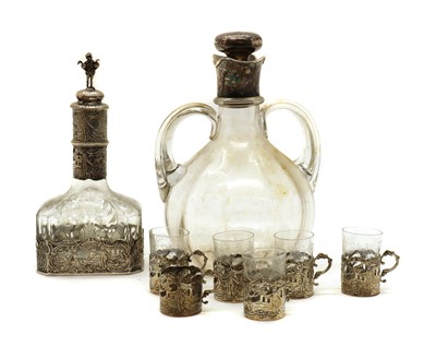 Lot 38 - A Dutch silver mounted decanter and six silver cup holders