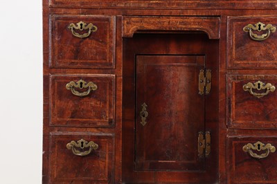 Lot 34 - A George II walnut and feather-banded kneehole desk