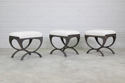 Lot 560 - A set of three cast bronze stools