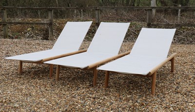 Lot 552 - A set of three modern wood sun loungers