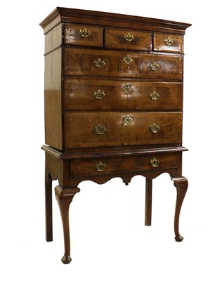 Lot 495 - A crossbanded walnut chest on stand